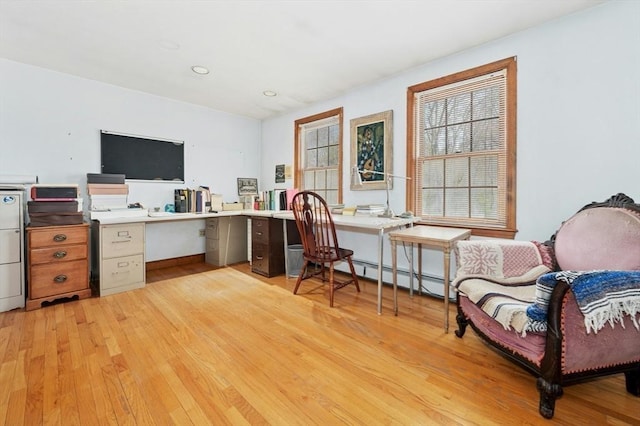 home office featuring recessed lighting, a baseboard heating unit, and light wood-style floors