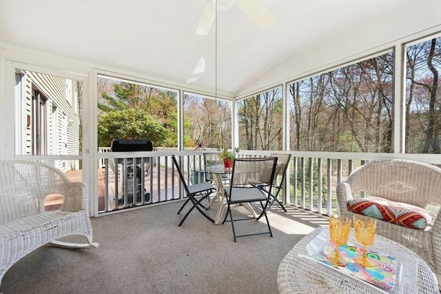 sunroom featuring ceiling fan and outdoor dining space