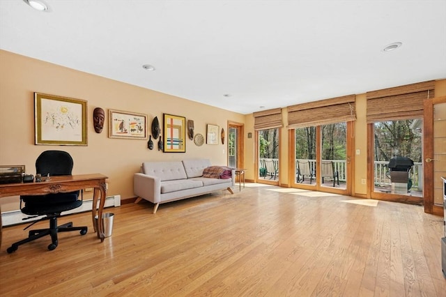 living area with recessed lighting, baseboards, and light wood finished floors
