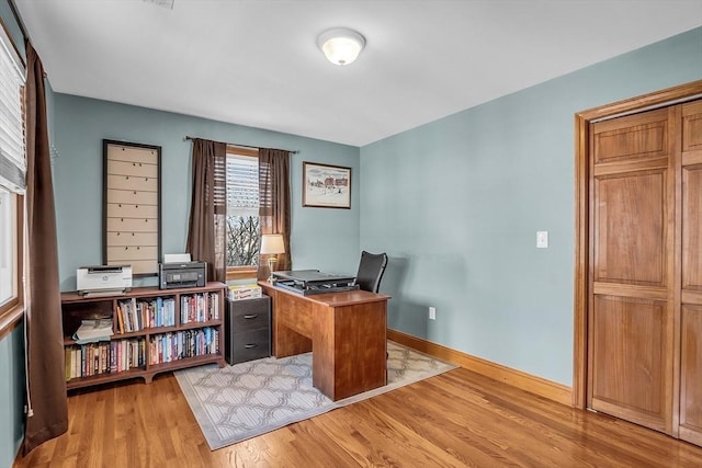 office area with light hardwood / wood-style floors