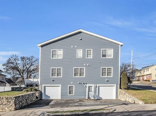 back of property with a garage