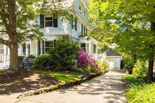 21 Waterston Rd, Newton, MA 02458 - view of front facade featuring a garage, a porch, and an outdoor structure