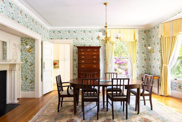 21 Waterston Rd, Newton, MA 02458 - dining room featuring wallpapered walls, a chandelier, wood finished floors, baseboards, and ornamental molding