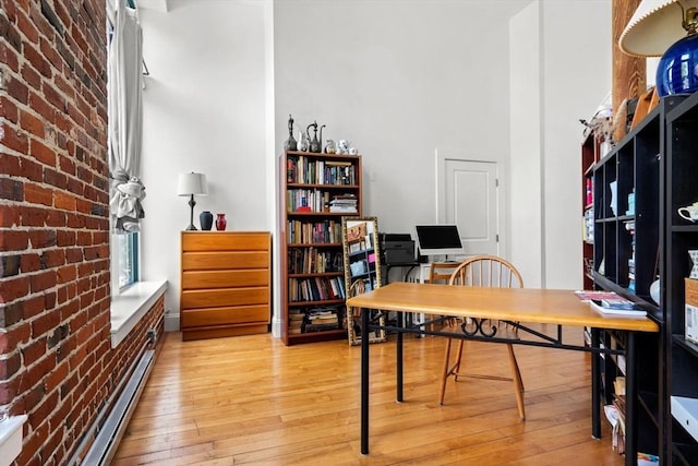 281 Essex St Unit 206, Salem, MA 01970 - office area with brick wall, light wood-type flooring, a high ceiling, and baseboard heating