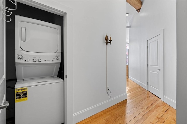 281 Essex St Unit 206, Salem, MA 01970 - washroom featuring stacked washer and clothes dryer, light wood finished floors, and baseboards