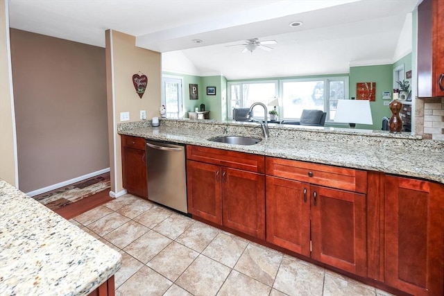 kitchen featuring light stone countertops, ceiling fan, a sink, vaulted ceiling, and dishwasher