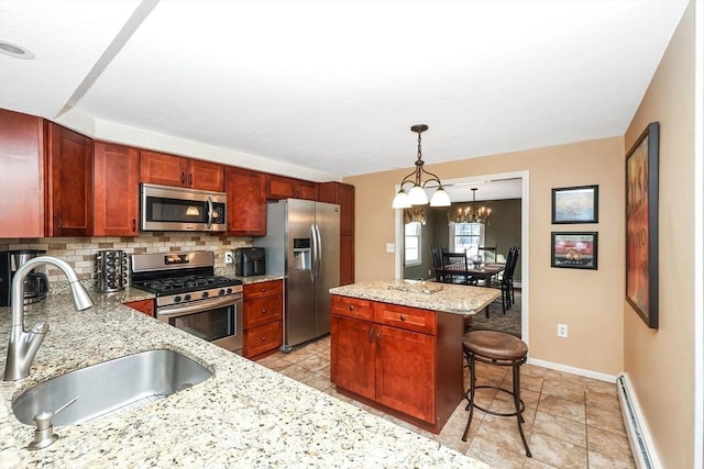 kitchen featuring a kitchen bar, a sink, tasteful backsplash, appliances with stainless steel finishes, and baseboard heating