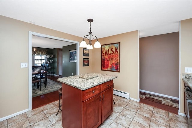 kitchen featuring light tile patterned floors, baseboards, a kitchen island, pendant lighting, and baseboard heating