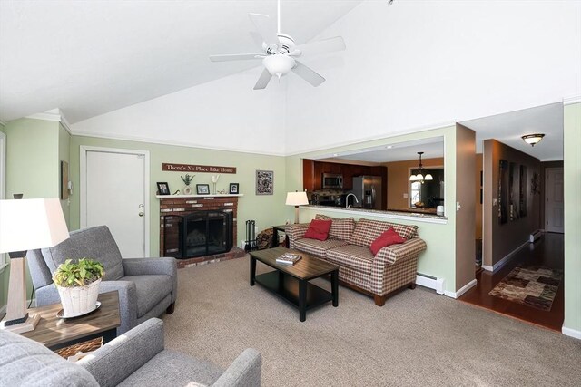 carpeted living room with high vaulted ceiling, a ceiling fan, a baseboard heating unit, a fireplace, and baseboards