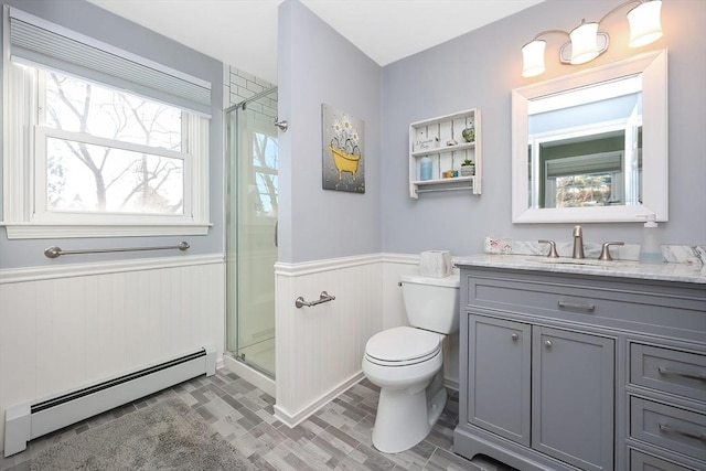 full bath featuring a shower stall, wainscoting, toilet, and a baseboard heating unit