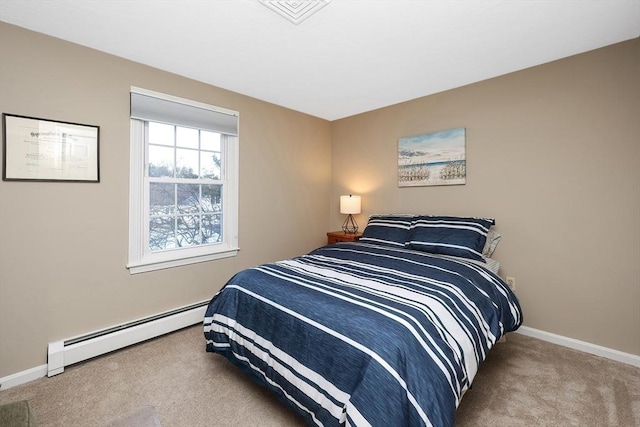 bedroom featuring a baseboard heating unit, baseboards, visible vents, and carpet floors