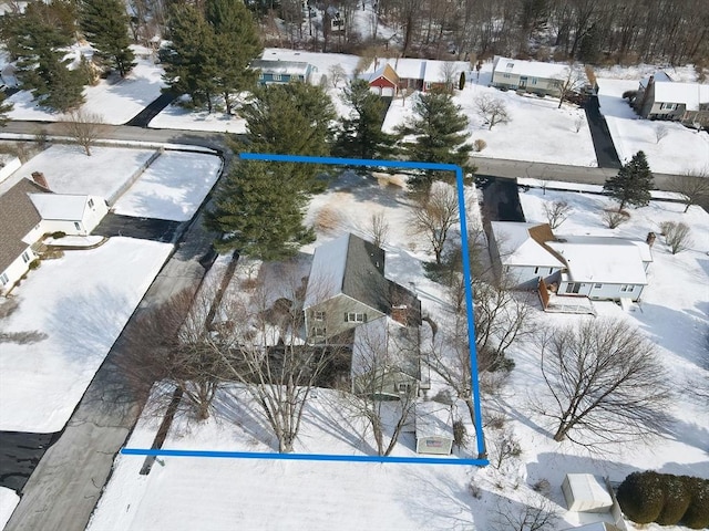 snowy aerial view with a residential view