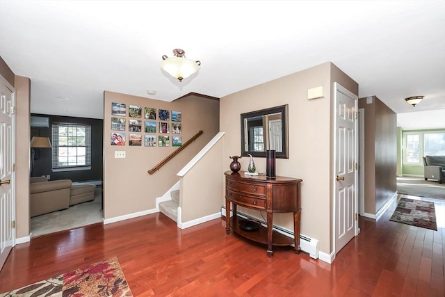 foyer featuring baseboards, wood finished floors, and stairs