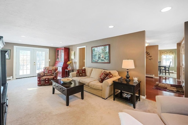 living area featuring recessed lighting, french doors, and light colored carpet