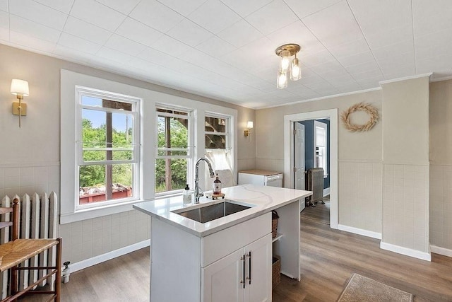 8 Holman St, Templeton, MA 01436 - kitchen with radiator, dark wood finished floors, light countertops, an island with sink, and ornamental molding