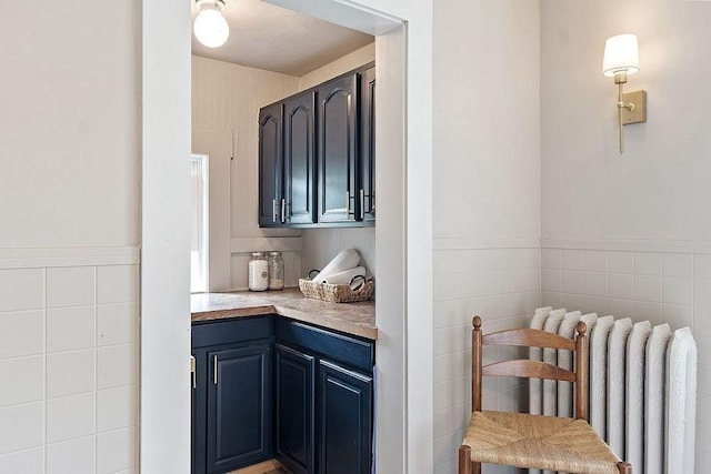 8 Holman St, Templeton, MA 01436 - bar with radiator heating unit, tile walls, and a wainscoted wall