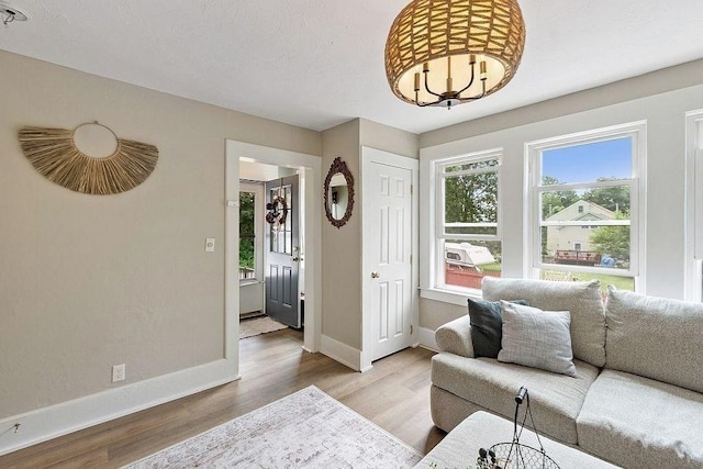 8 Holman St, Templeton, MA 01436 - living room with wood finished floors, a chandelier, and cooling unit