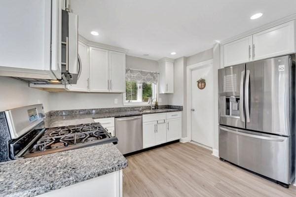 135 Pine Grove Ave, Lynn, MA 01904 - kitchen featuring stainless steel appliances, white cabinets, light wood-style floors, light stone countertops, and recessed lighting
