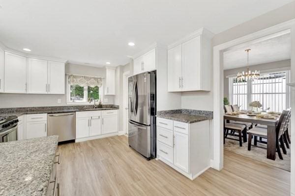 135 Pine Grove Ave, Lynn, MA 01904 - kitchen with stainless steel appliances, light wood finished floors, white cabinets, light stone countertops, and recessed lighting