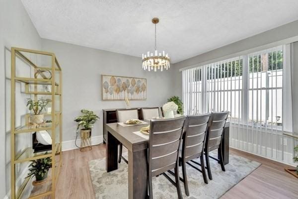 135 Pine Grove Ave, Lynn, MA 01904 - dining area featuring plenty of natural light, wood finished floors, and a chandelier