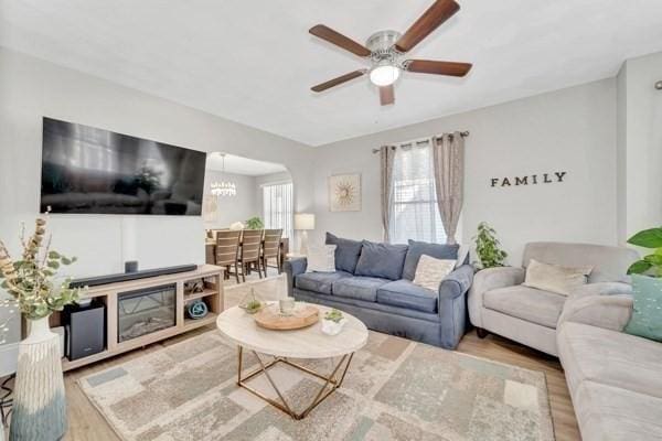 135 Pine Grove Ave, Lynn, MA 01904 - living area with wood finished floors, ceiling fan, arched walkways, and a chandelier