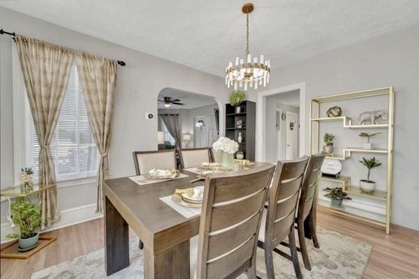 135 Pine Grove Ave, Lynn, MA 01904 - dining area with wood finished floors, a chandelier, arched walkways, and baseboards