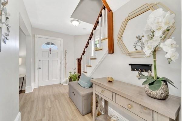 135 Pine Grove Ave, Lynn, MA 01904 - entrance foyer with light wood-style flooring, stairs, and baseboards