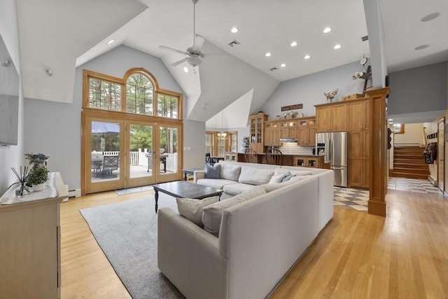 living room featuring recessed lighting, high vaulted ceiling, light wood-type flooring, a ceiling fan, and visible vents