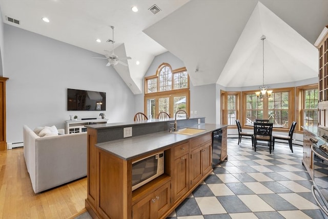 kitchen featuring a sink, visible vents, baseboard heating, black dishwasher, and white microwave