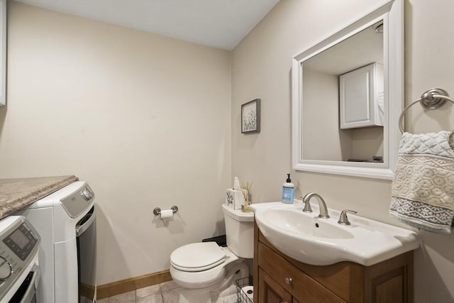 half bathroom featuring tile patterned floors, toilet, vanity, and baseboards