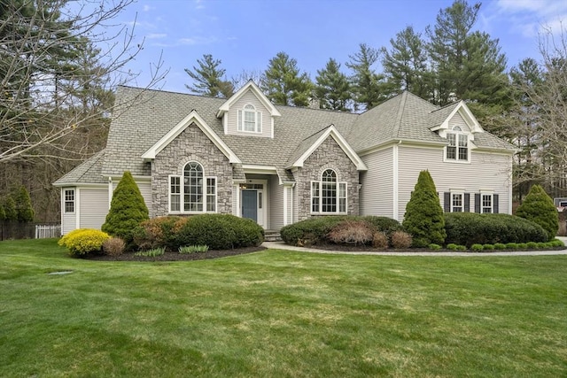 view of front of house with a front yard and stone siding