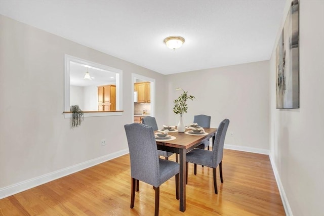 dining space with hardwood / wood-style flooring