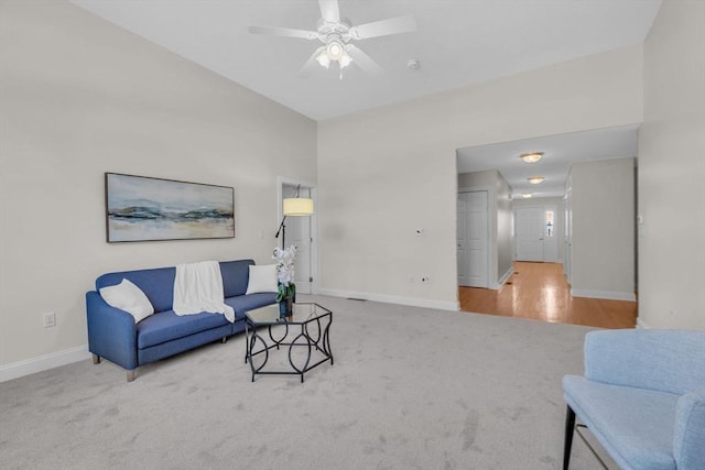 living room featuring carpet and ceiling fan