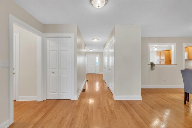 corridor featuring light hardwood / wood-style flooring