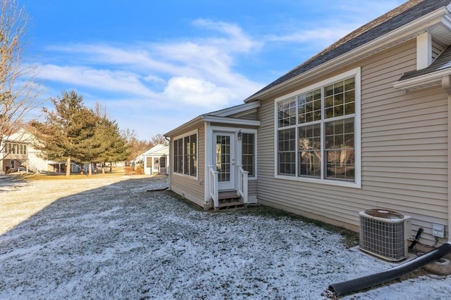 snow covered property featuring central air condition unit