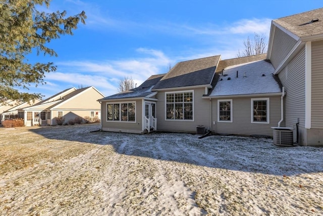 rear view of house featuring central AC