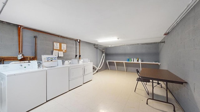 community laundry room with light floors and washer and clothes dryer