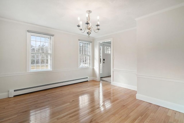 unfurnished dining area featuring a notable chandelier, baseboard heating, plenty of natural light, and wood-type flooring