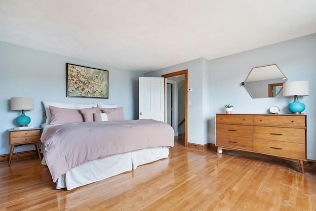 bedroom with baseboards and light wood finished floors