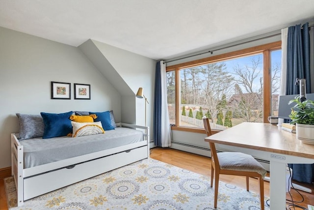 bedroom featuring light wood-style flooring and baseboard heating