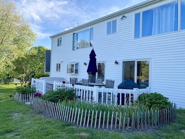 rear view of house featuring a yard and a wooden deck