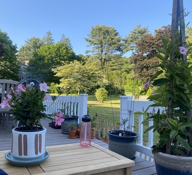 wooden deck with a lawn