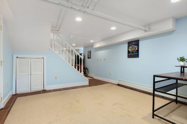 basement with recessed lighting, baseboards, a baseboard radiator, and stairs