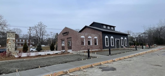 view of side of home featuring brick siding