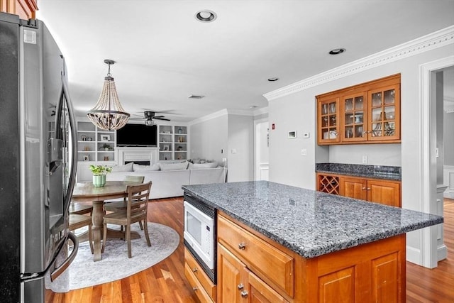 17 Maplewood Dr, Hanover, MA 02339 - kitchen featuring stainless steel fridge, white microwave, wood finished floors, brown cabinetry, and a center island