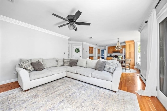 17 Maplewood Dr, Hanover, MA 02339 - living room featuring light wood-style flooring, a baseboard radiator, ceiling fan, and crown molding