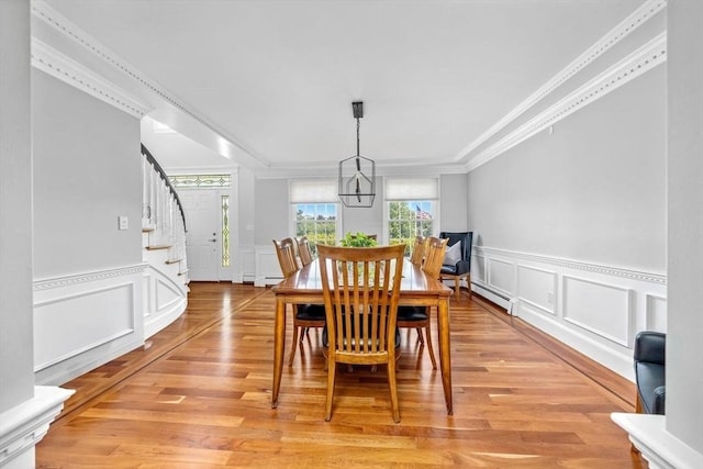17 Maplewood Dr, Hanover, MA 02339 - dining space with a decorative wall, ornamental molding, stairway, light wood-style flooring, and a wainscoted wall