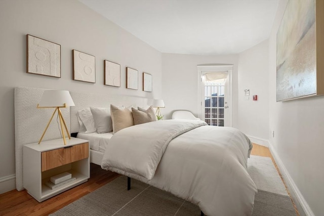 bedroom with wood finished floors and baseboards
