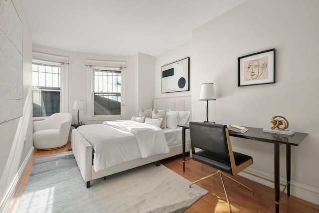 bedroom featuring wood finished floors and baseboards