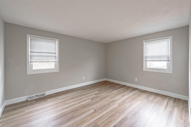 empty room with light hardwood / wood-style floors